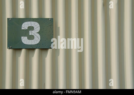 Number 1 on a corrugated steel wall Stock Photo