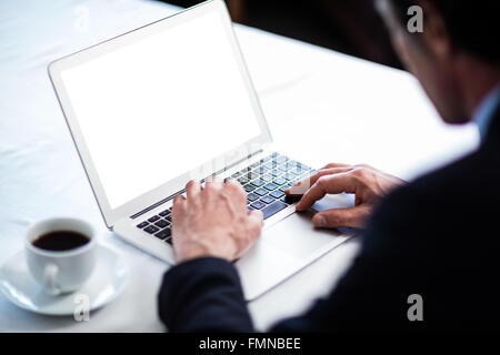 Businessman using his laptop at restaurant Stock Photo