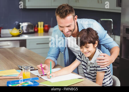 Father assisting boy in solving maths Stock Photo