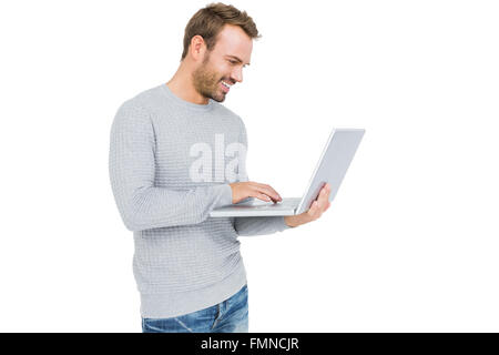 Happy young man using laptop Stock Photo