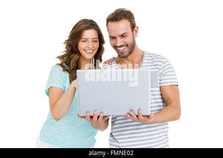 Happy young couple using laptop Stock Photo