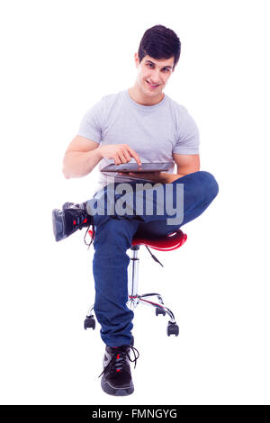 Smiling handsome latin man using a tablet computer, isolated over a white background Stock Photo