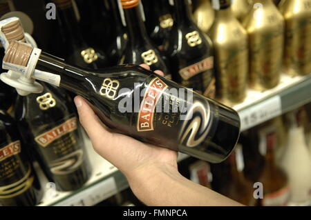 Baileys bottle being held at Carrefour - Malaga, Spain