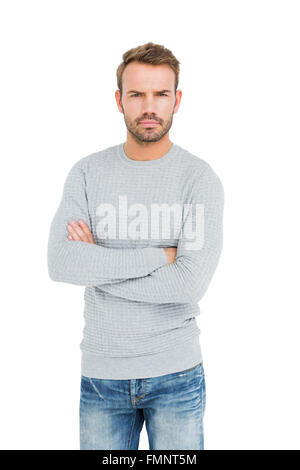 Serious man standing with arms crossed Stock Photo