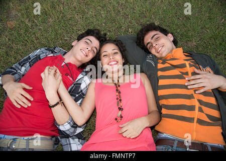 Three young college students having fun outdoors Stock Photo