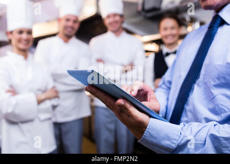 Mid section of manager using digital tablet Stock Photo
