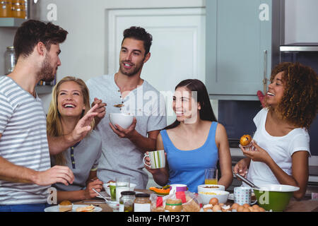 Cheerful friends discussing while having breakfast Stock Photo