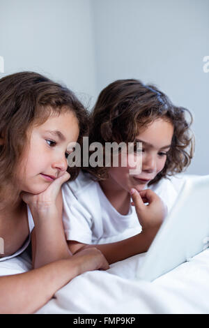 Brother and sister using digital tablet Stock Photo