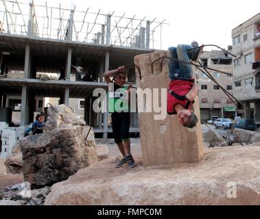 Damascus, Syria. 12th Mar, 2016. Children play near an abandoned building in the southern suburbs of Damascus, Syria, March 12, 2016. The Syrian civil war since March 2011 has made the Middle East country the world's single-largest source of refugees and displaced people, according to UN figures. The long-running conflict has claimed at least 250,000 lives and forced over 2 million children out of school. © Yang Zhen/Xinhua/Alamy Live News Stock Photo