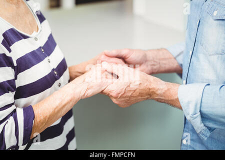 Midsection of senior couple holding hands Stock Photo