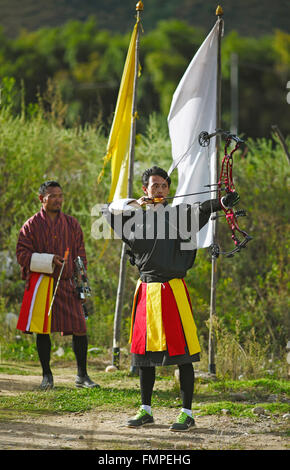 Archers with a high-tech bow wearing Gho dresses, Paro, Paro province, Kingdom of Bhutan Stock Photo