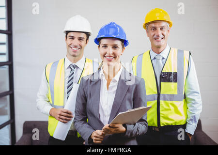 Portrait of smiling architects with clipboard Stock Photo - Alamy