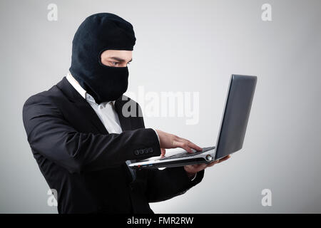 Hacker stealing information from laptop Stock Photo