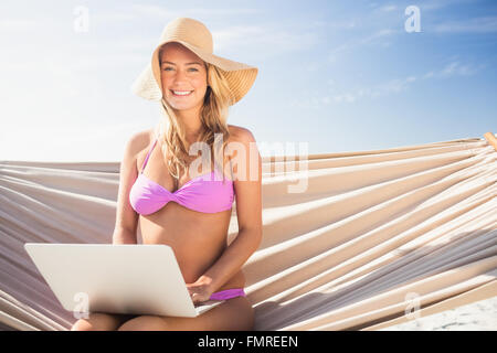 Woman using her laptop in hammock Stock Photo