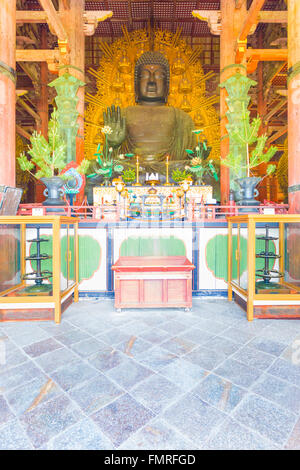 Front of the centered largest bronze Daibutsu statue and altar inside Great Buddha Hall, Daibutsuden, at Todai-ji temple in Nara Stock Photo