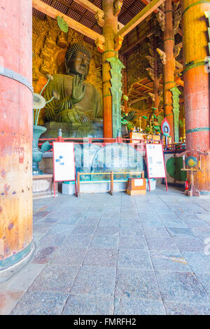 Angled profile of the world's largest bronze Buddha statue inside the Great Buddha Hall, Daibutsuden, at Todai-ji temple in Nara Stock Photo