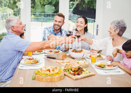 Happy family toasting red wine Stock Photo