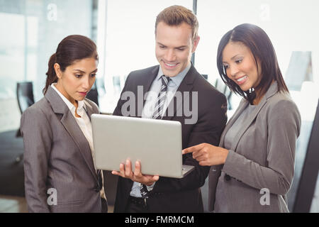 Businesspeople looking at laptop Stock Photo