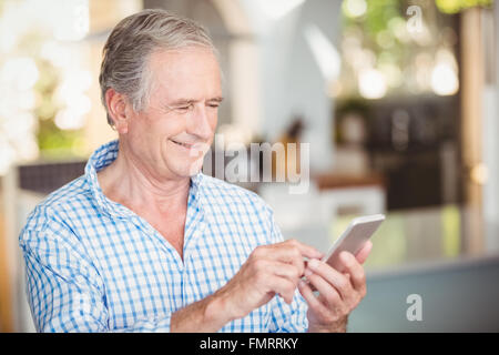 Happy senior man using mobile phone Stock Photo