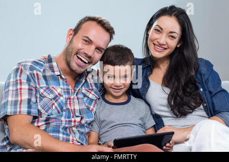 Mother, father and son using digital tablet Stock Photo
