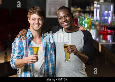 Happy friends having a drink Stock Photo
