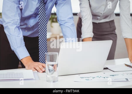 Midsection of business people using laptop Stock Photo