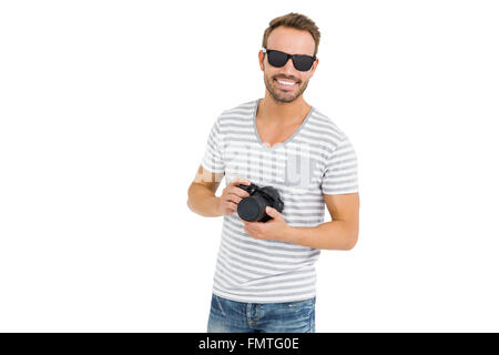 Young man holding digital camera Stock Photo