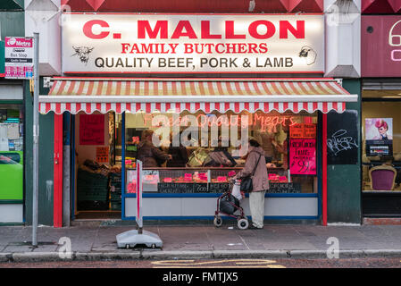 Traditional family butcher shop with a neon sign which reads 'Finest Quailty [sic] Meats' Stock Photo