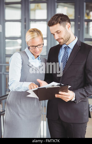 Business people discussing over documents in office Stock Photo
