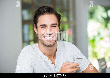 Smiling man holding smartphone Stock Photo