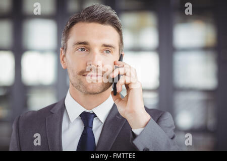 Handsome businessman talking on cellphone Stock Photo