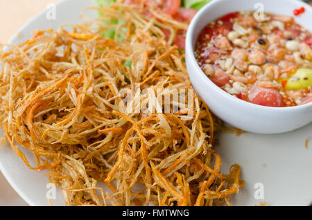 Deep fried papaya salad with spicy sauce Stock Photo