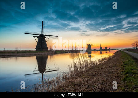 on the water there are several windmills in Kinderdijk in Holland Stock Photo