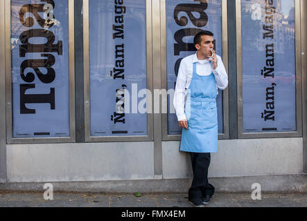 Waiter, smoking break, in Plaza de la Independencia. Madrid, Spain. Stock Photo