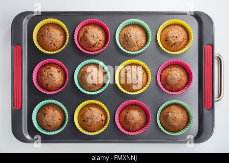 Cakes in molds on a tray after baking in the oven Stock Photo