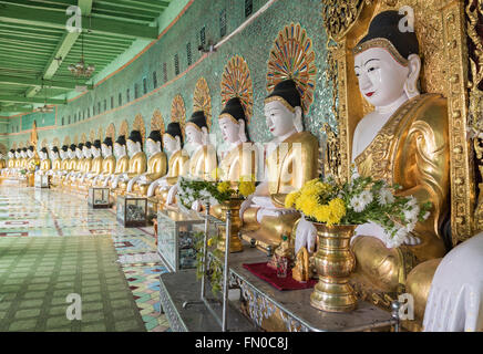 Row of statues of seated Buddhas in Umin Thounzeh (U Min Thonze) Pagoda on Sagaing Hill near Mandalay, Myanmar (Burma) Stock Photo