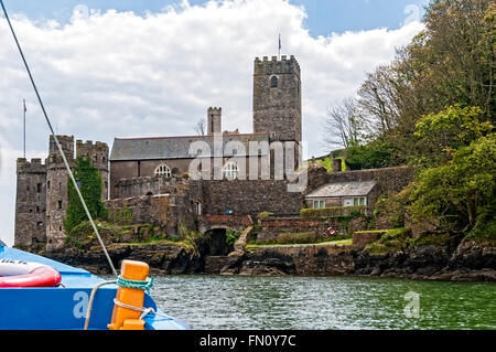 Overlooking the entrance to the river Dart St Petrox Church is situated adjacent to  the limestone structure of Dartmouth Castle Stock Photo