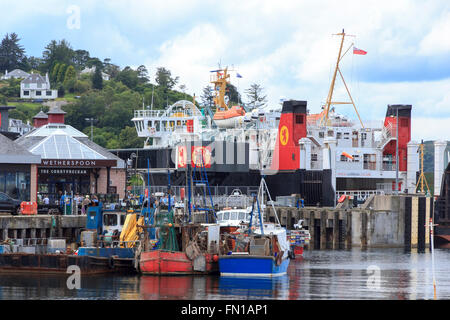 The Calmac car ferry Lord of the Isles moored in Oban harbour, with its popular Wetherspoon pub on the jetty. Stock Photo