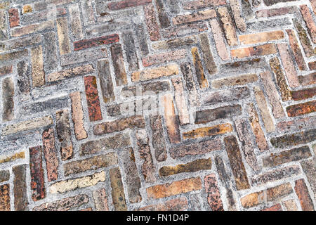 Old weathered red brick pavement, close-up background texture Stock Photo