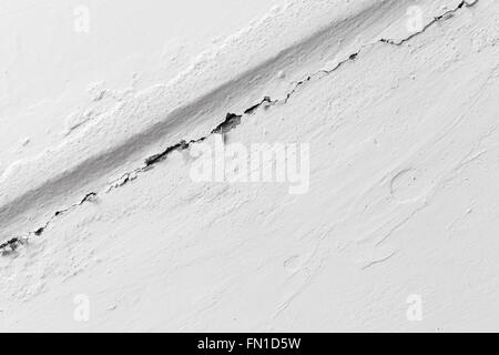 Crack in white painted wall, closeup photo texture Stock Photo