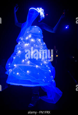 A model walks across the catwalk during a blacklight fashion show for the opening of the 'Luminale' light spectacle in Offenbach, Germany, 12 March 2016. This year's Luminale takes place from 13 to 18 March 2016 and features around 200 light installations in Frankfurt and Offenbach. Photo: BORIS ROESSLER/dpa Stock Photo