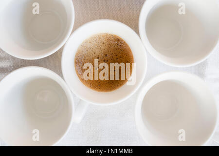 creamy espresso coffee in a white cup with near others white cup Stock Photo