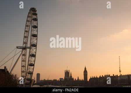 London, UK. 13th March 2016. UK Weather: South Bank sunset. Big Ben and the London Eye bask in mellow light as the sun begins to go down. Credit: Patricia Phillips/Alamy Live News Stock Photo
