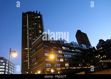 Barbican apartment tower and flats with streetlights and blue sky in the evening  London EC2Y  UK  KATHY DEWITT Stock Photo