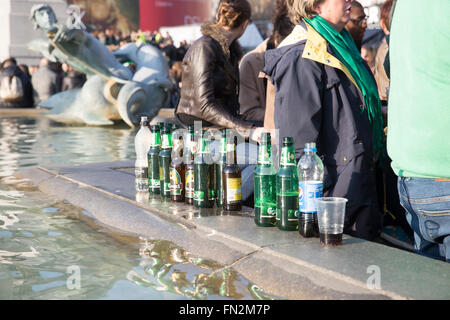 London,UK,13th March 2016,Bottles left on the fountain wall as huge crowds attend London's St Patrick’s Day Festival in Trafalgar Square Londo Credit: Keith Larby/Alamy Live News Stock Photo