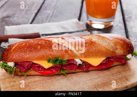 sandwich baguette cheese salami tomato sauce and herbs Stock Photo
