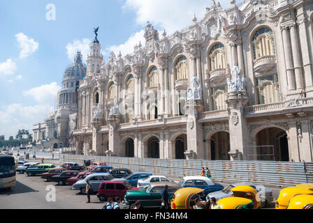 Distinctive Coco taxis and vintage cars wait for tourist business on Paseo del Prado in central Havana Cuba Stock Photo