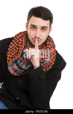Young Man is Asking for Silence, isolated on white background Stock Photo