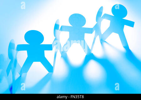Team of paper doll people. Blue tone. Stock Photo