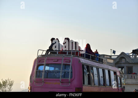 People traveling on the roof of a bus, village of Sudal near Nagarkot, Kathmandu Valley, Nepal Stock Photo